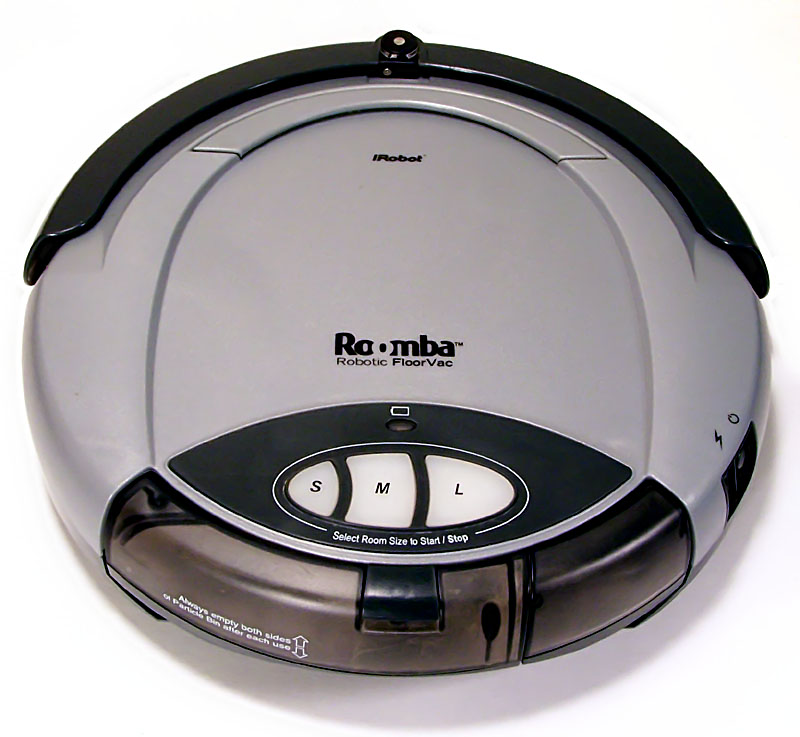 Original iRobot Roomba disc-shaped robot vacuum on a light floor